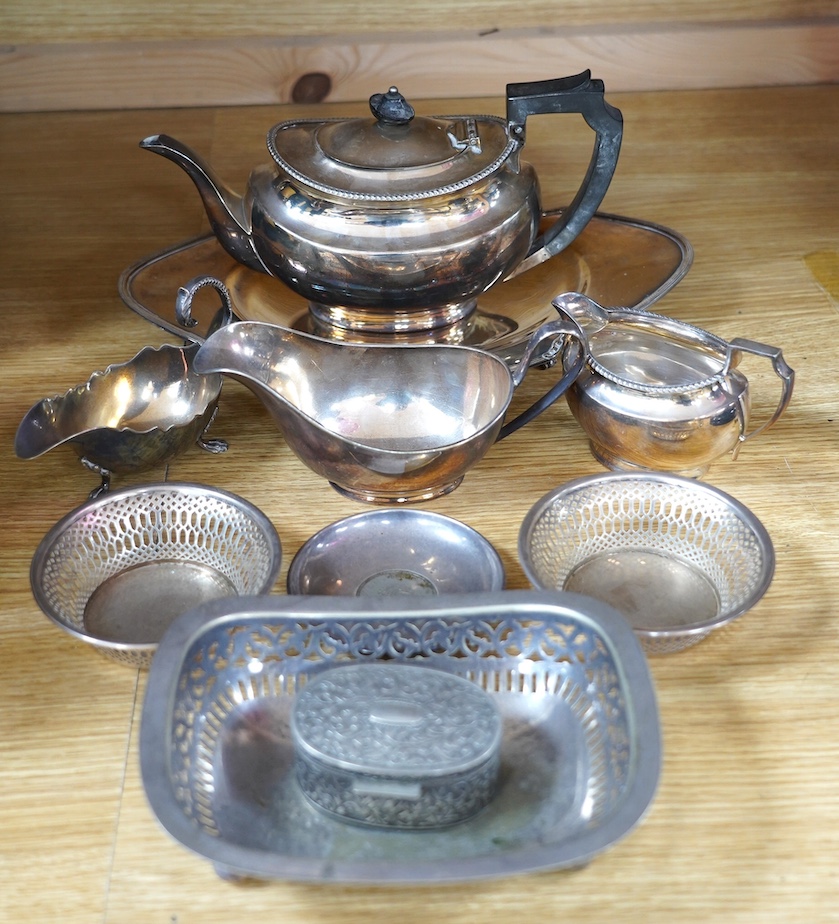 A pair of George V pierced silver bonbon dishes, Birmingham 1928, 11.8cm, a modern silver coin dish and a small group of silver plated items including a teapot and two sauceboats, etc. Condition - fair